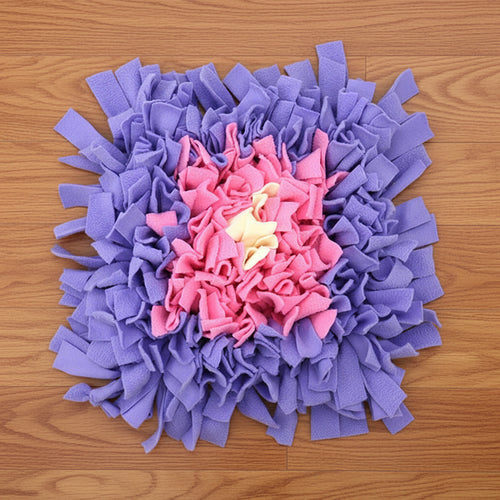 Purple and pink snuffle mat on a wood floor