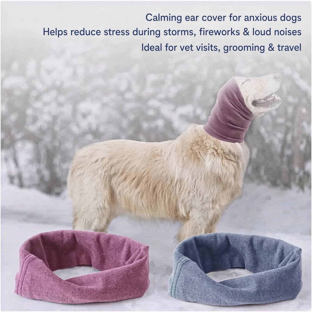 A fluffy cream-colored dog stands in a snowy outdoor setting wearing a purple calming ear cover. Two matching ear covers are shown in the foreground, one purple and one blue-gray, with marketing text at the top describing the product benefits.