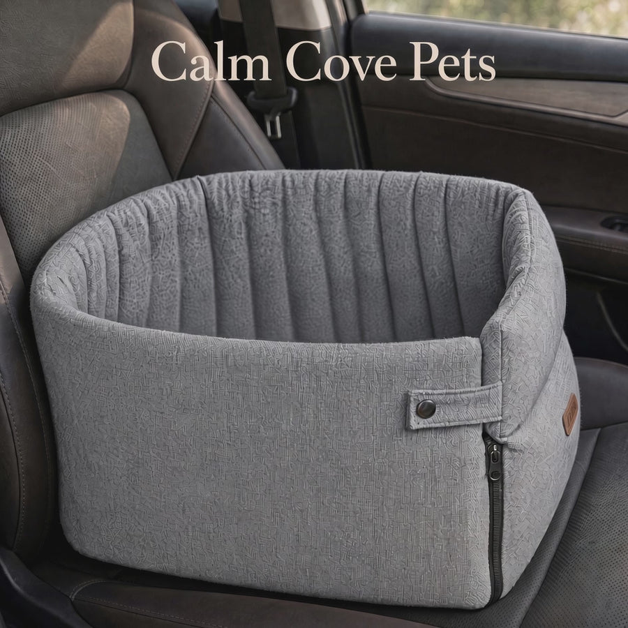 A video of a gray fabric pet car bed with a zippered side and padded rim, shown placed on a car seat. The text 'Calm Cove Pets' appears at the top.
